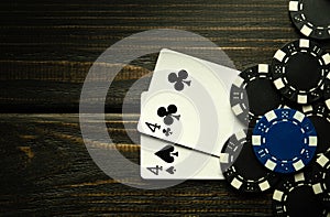 Playing poker with a winning combination of one pair. Cards with chips on a black vintage table in a poker club