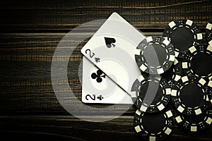 Playing poker with a winning combination of one pair. Cards with chips on a black vintage table in a poker club. Copy space