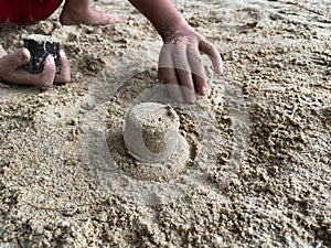 playing sand castles on the beach.