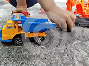 Playing sand using excavator and dump truck toys