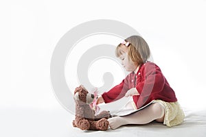 Playing school with toys. happy smiling baby girl elegant in dress. cute caucasian baby with teddy bear