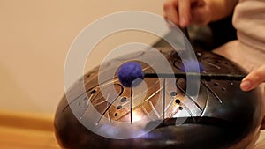 Playing on the steel tongue drum