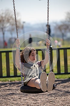 Playing on a swing in a park