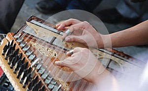 Playing Turkish Qanon Musical Instrument. Selective focus photo