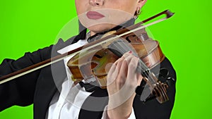 Playing a violin close up. Green screen