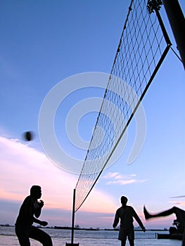 Playing volleyball at sunset