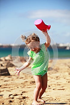 Playing with water on sandy beach