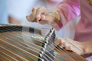 Playing the zither's moment