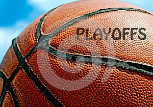 Playoffs written on an orange basketball