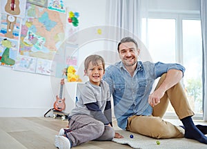 Playtime with Dad. Portrait of a happy father and son playing marbles together at home.