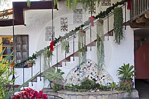 Plaza center with hanging plants and pots on stairs against an a