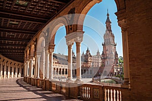 The Plaza de EspaÃÂ±a galleries lited up with evening sunlight making magic shadows. North tower view on Spain Square, Andalusia, photo