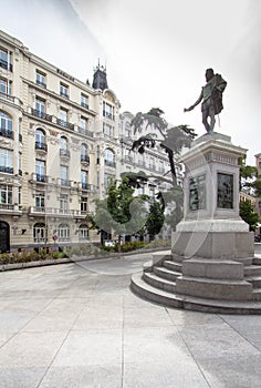 Plaza de las Cortes with statue of Miguel de Cervantes and to the building Plus Ultra Seguros, Madrid, Spain photo