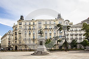 Plaza de las Cortes with statue of Miguel de Cervantes and to the building Plus Ultra Seguros, Madrid, Spain photo