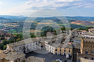 The plazas and roof tops rise above the countryside in Orvieto, Italy photo