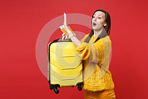 Pleading woman late, asking to stop by waving hand looking aside hold suitcase passport boarding pass ticket isolated on