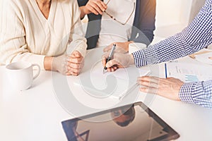 Pleasant aged couple meeting with real estate agent