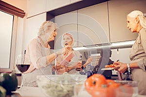 Pleasant aged women arguing about the recipe