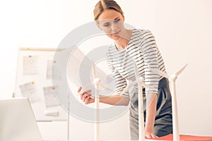 Pleasant attractive woman leaning over the table