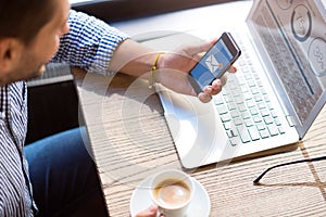 Pleasant bearded man sitting at the table