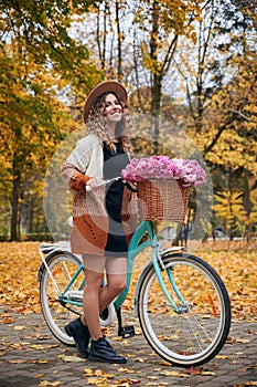 Beautiful girl outdoors with woman& x27;s retro bicycle.