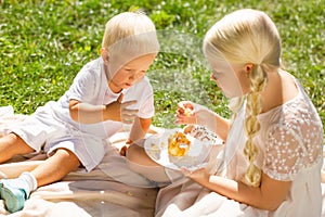 Pleasant brother and sister eating tasty sweets