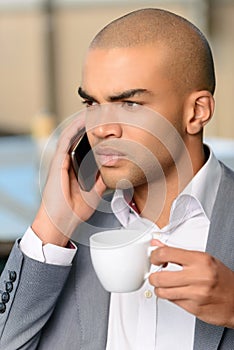 Pleasant businessman drinking coffee