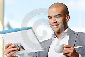 Pleasant businessman drinking coffee