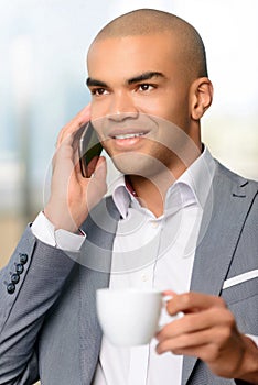 Pleasant businessman drinking coffee