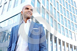 Pleasant businessman standing near office