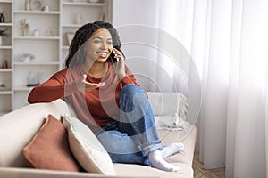 Pleasant Chat. Happy Young Black Woman Talking On Cellphone At Home