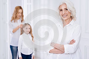 Pleasant cheerful senior woman resting with her family at home photo