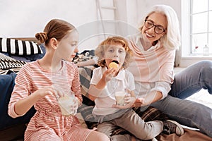 Pleasant cute boy eating a cookie