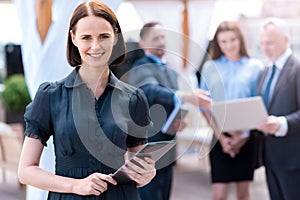 Pleasant delighted woman holding tablet