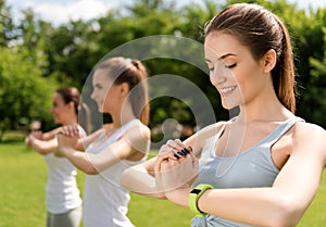 Pleasant delighted women doing sport exercises outdoors
