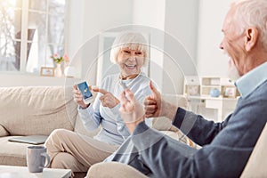 Pleasant elderly couple being happy about nice weather forecast