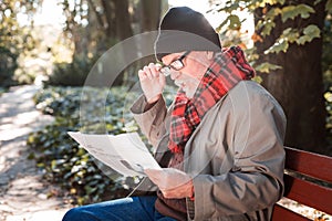 Pleasant elderly man holding a morning newspaper
