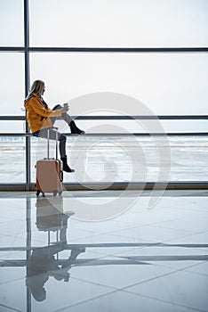 Pleasant girl is enjoying view at airport