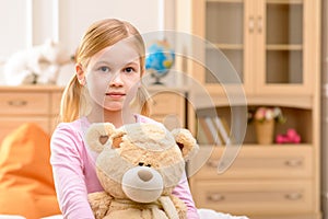 Pleasant girl holding bear