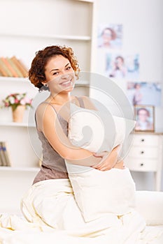 Pleasant girl resting in bed