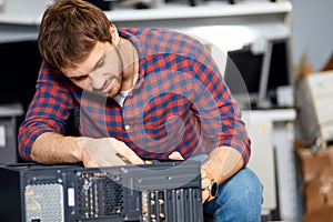 Pleasant guy taking apart a system unit