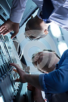 Pleasant handsome engineers working in the data center