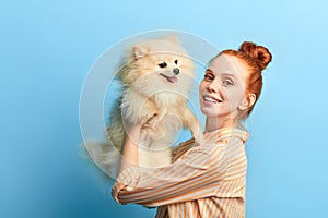 Pleasant kind cute girl holding her adorable pet