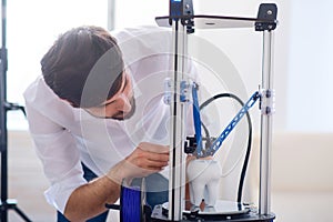 Pleasant man using 3d printer