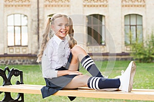 Pleasant minutes of rest. Time to relax and have fun. Relaxing in school yard. Perfect schoolgirl relaxing between