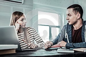 Pleasant nice couple studying at home together