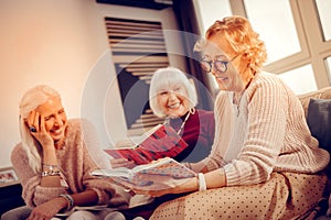 Pleasant nice woman holding her favourite book