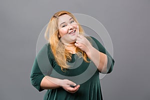 Pleasant obese woman looking at you