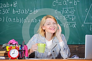 Pleasant relax after classes. Working conditions which prospective teachers must consider. Woman smiling teacher holds