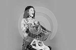 Pleasant shopping. happy girl hold shopping cart. Buyer in supermarket. customer with empty cart. female shopper with